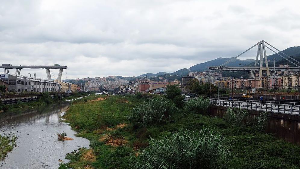The Morandi motorway bridge is seen from a distance after a section collapsed earlier in Genoa on August 14, 2018. 