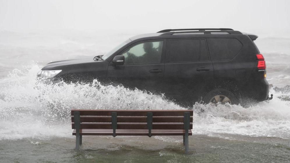 A car drives through floodwater in Galway
