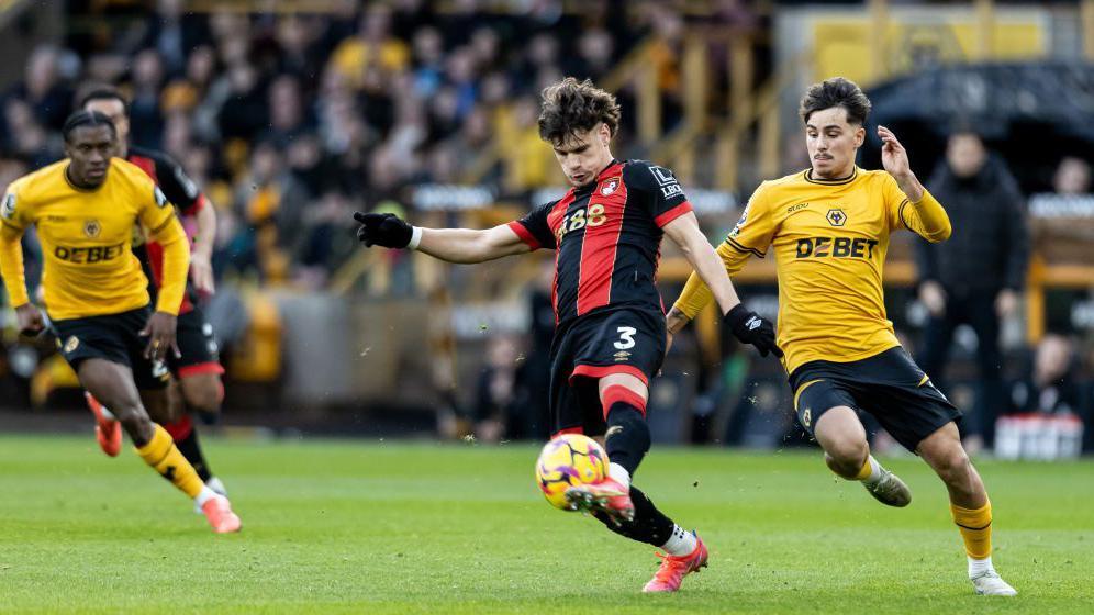 Wolverhampton Wanderers' Rodrigo Gomes (right) chasing down AFC Bournemouth's Milos Kerkez during the Premier League match between Wolverhampton Wanderers FC and AFC Bournemouth at Molineux on November 30, 2024