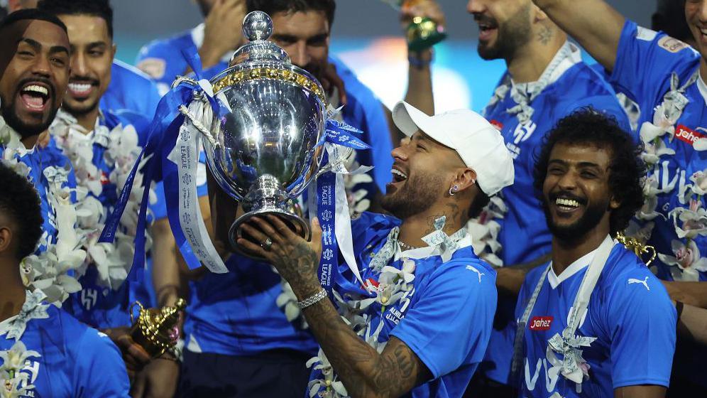  Neymar Jr of Al Hilal celebrates with the trophy 