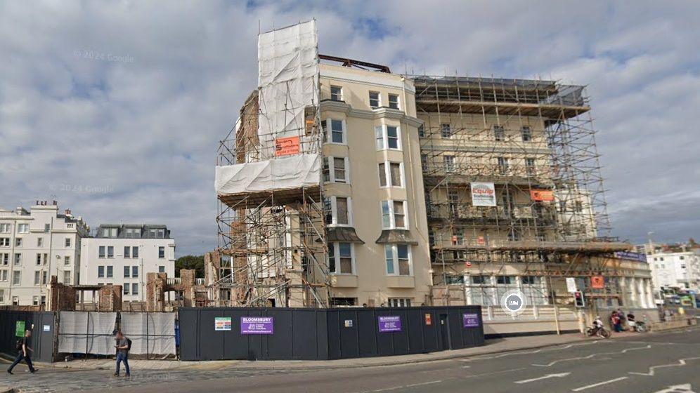 The remains of the Royal Albion Hotel in September, with much of the building  covered tarpaulin and scaffolding.