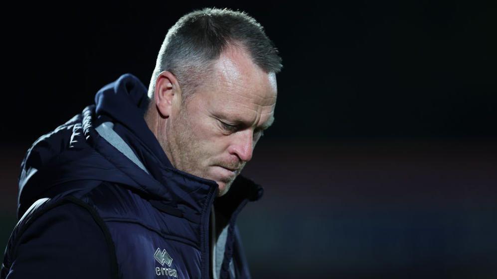 A dejected looking Cheltenham Town manager Michael Flynn