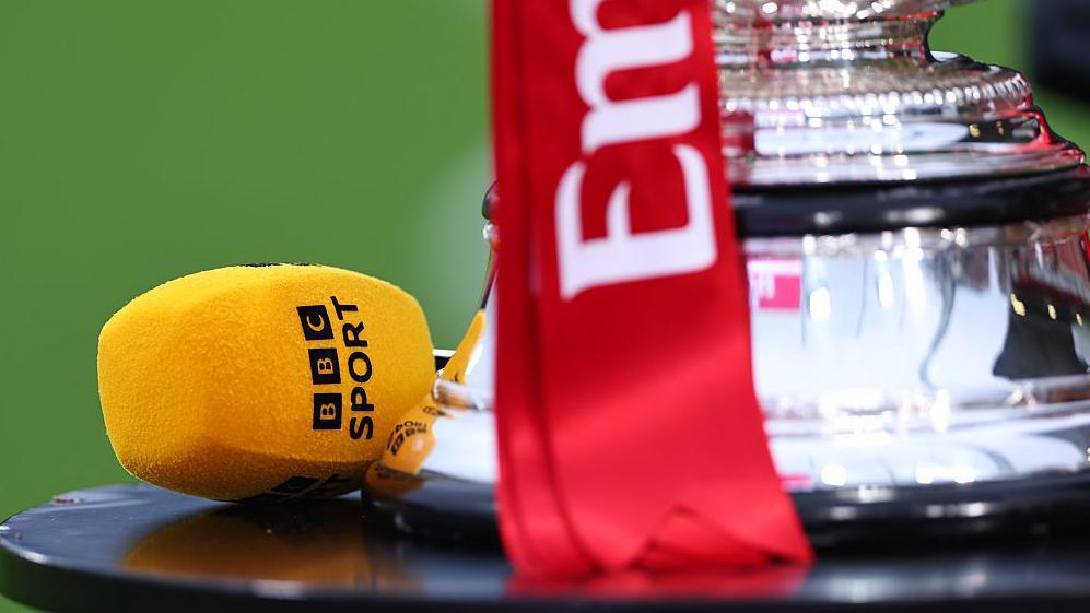 The FA Cup trophy and a BBC Sport microphone