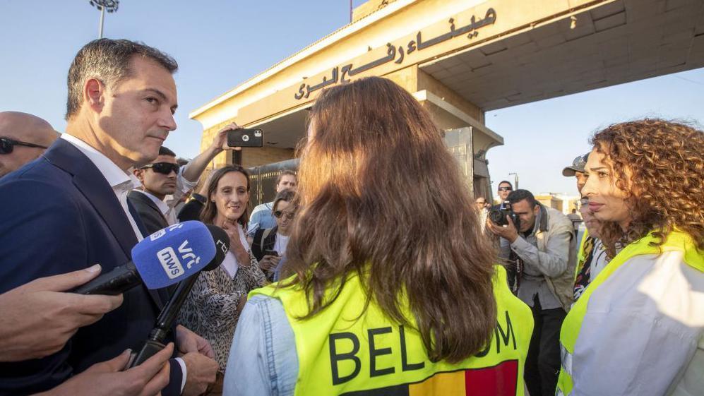 Prime Minister Alexander De Croo talks to Belgian social workers in support for Belgian citizens crossing the border during a visit to the city of Rafah, in the southern Gaza Strip in the State of Palestine, Friday 24 November 2023