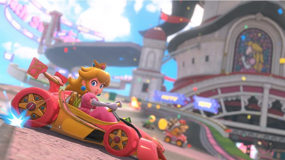 Super Mario character Peach driving a pink F1 style racing car. In the background is her iconic castle building from Super Mario 64.