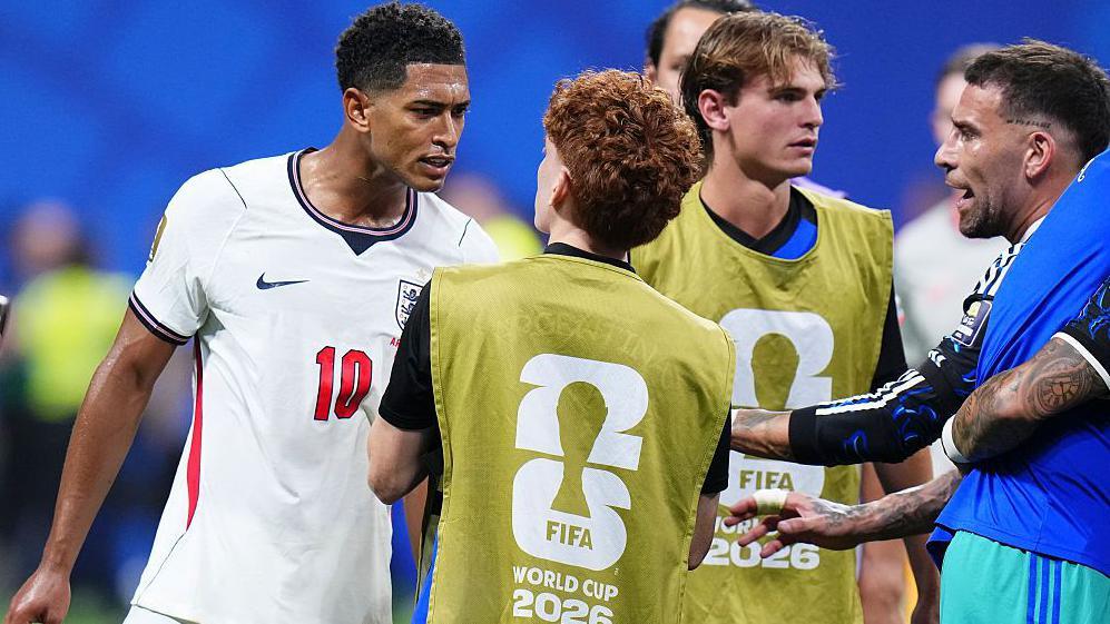 Jude Bellingham of England confronts Valentin Barco of Argentina at the World Cup semi-final between England and Argentina at Atlanta Stadium