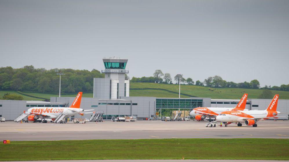 A view of Bristol Airport with EasyJet planes parked outside on the runway