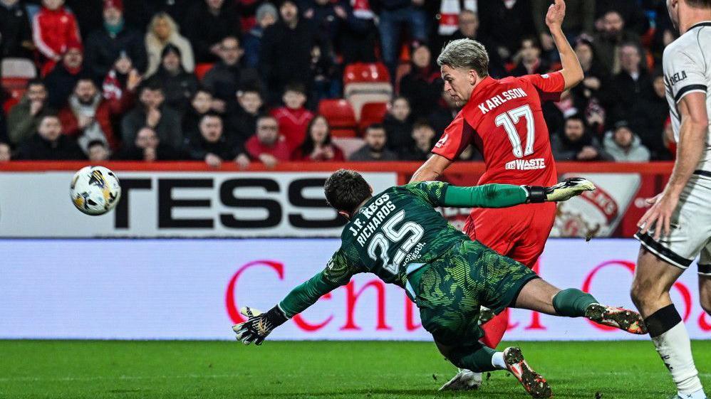 Aberdeen's Jesper Karlsson (centre) scores