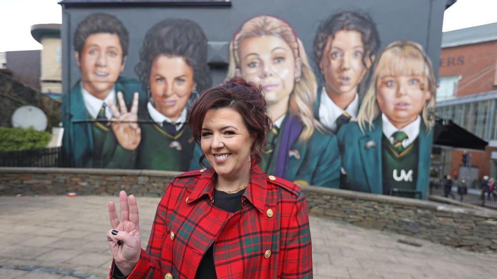 Derry Girls creator Lisa McGee pictured in front of the mural before the awning was installed. 