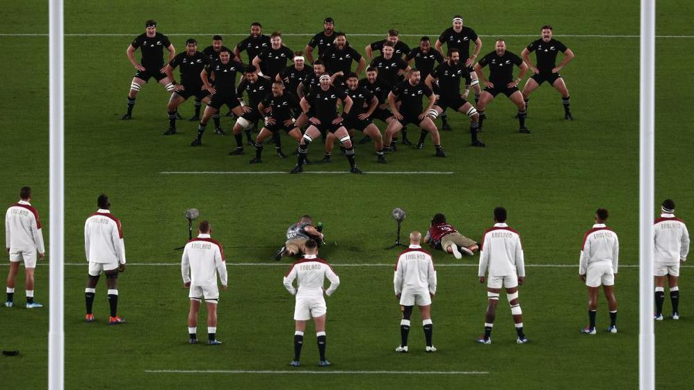 England respond in a V formation to the New Zealand haka in 2019