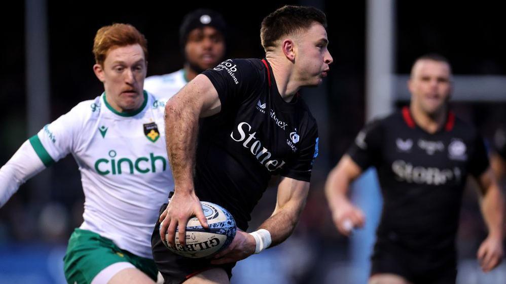 Fergus Burke passes the ball in Saracens' win over Northampton Saints