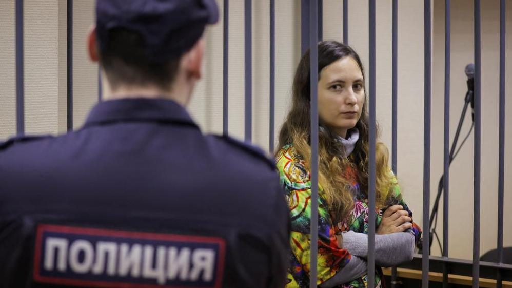 A woman in a cell in a Russian court