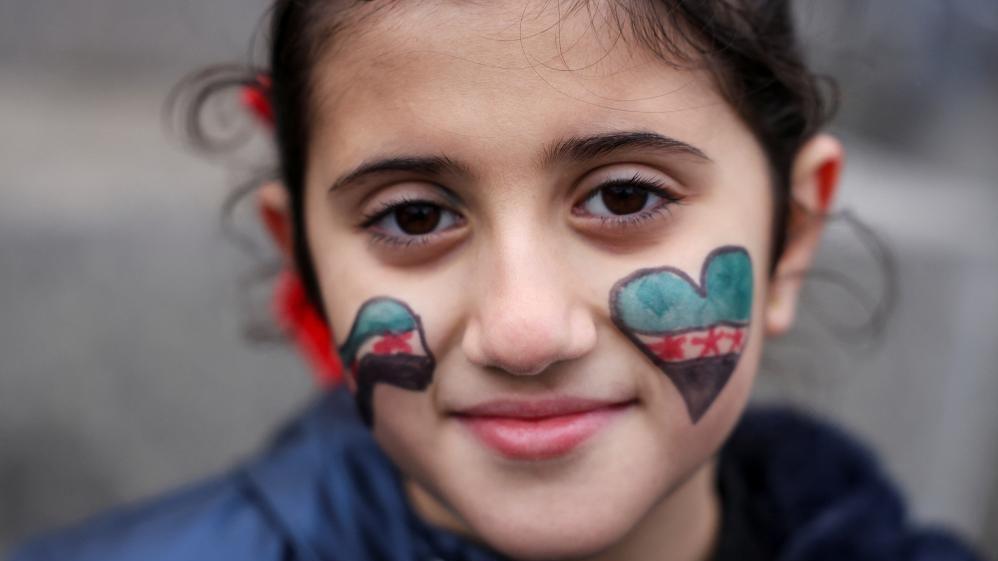 Lareen, 8, looks on as people gather in Trafalgar Square, London, on December 8, 2024 