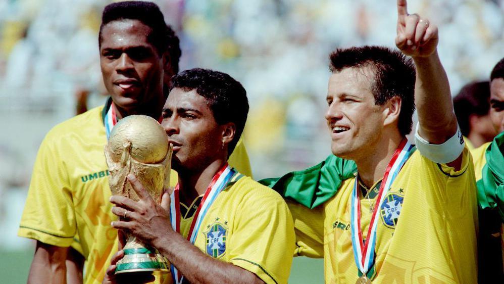 Romario kisses the World Cup trophy after Brazil's penalty shootout win over Italy in 1994