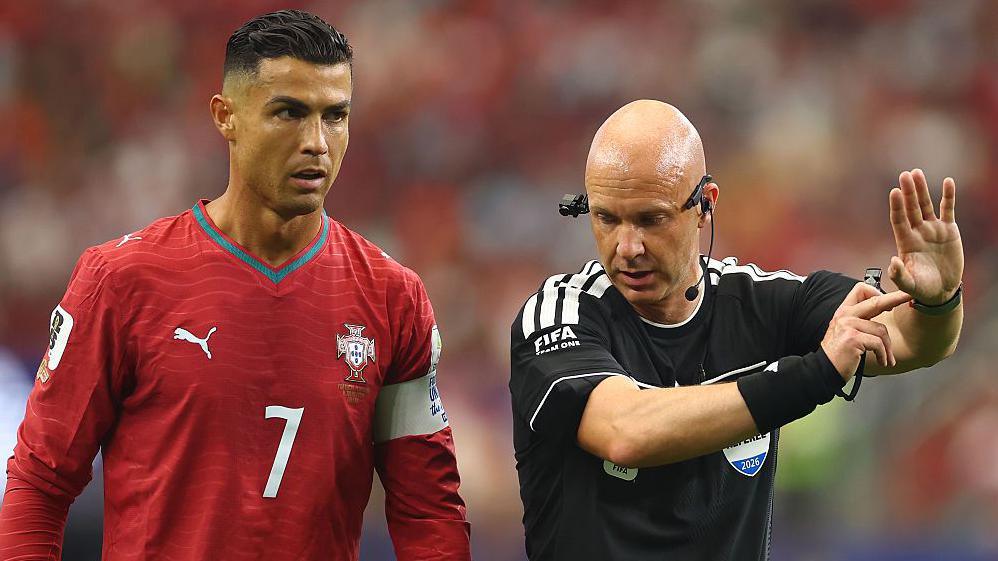 Cristiano Ronaldo and Anthony Taylor