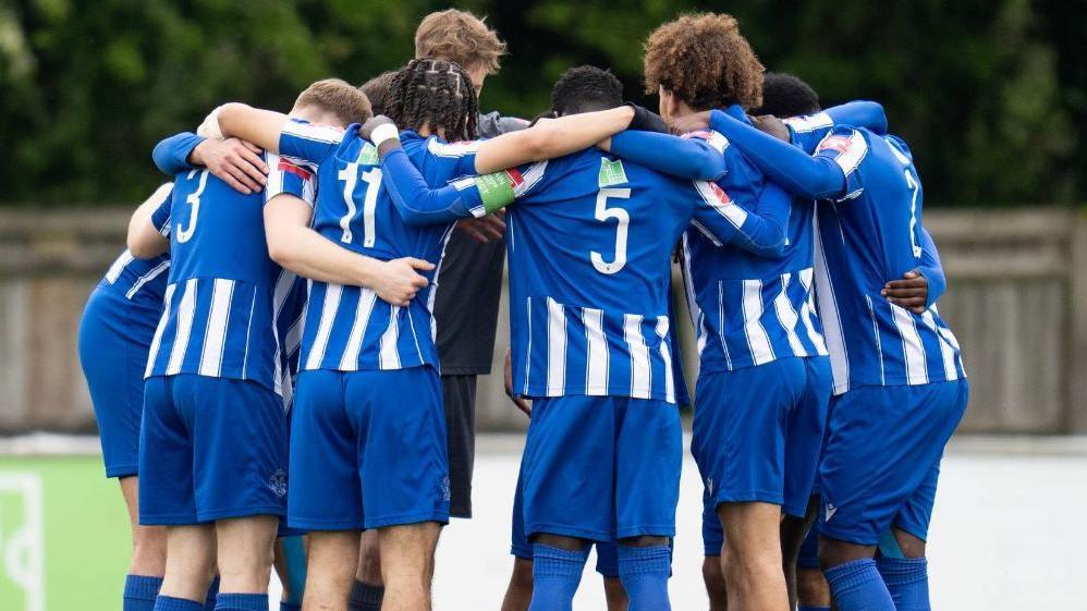 Thatcham Town players in a huddle at a match