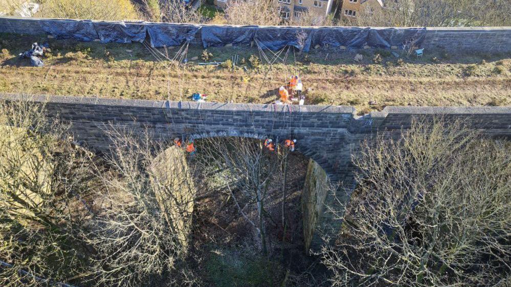 Work being undertaken on and below the deck of the viaduct