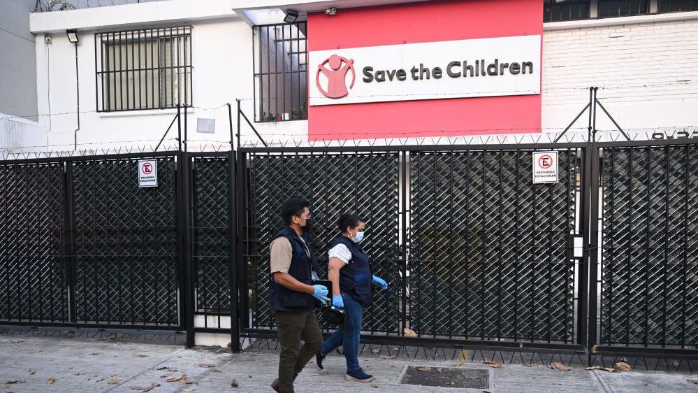 Two officers walking past the outside of STC office in Guatemala