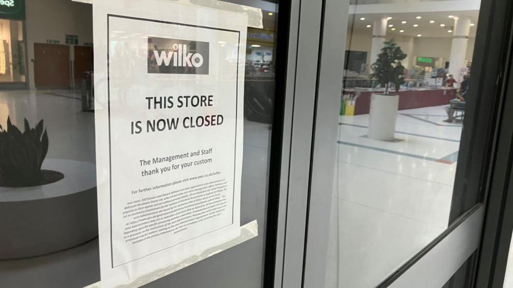 A sign on the empty Wilko unit which reads: "This store is now closed."