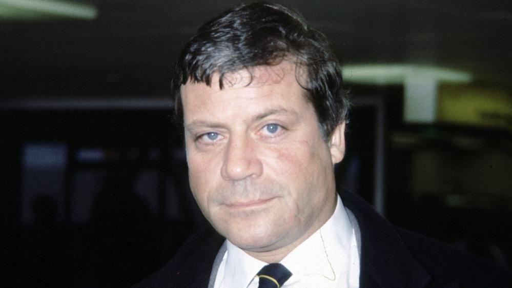 Oliver Reed poses for a photograph