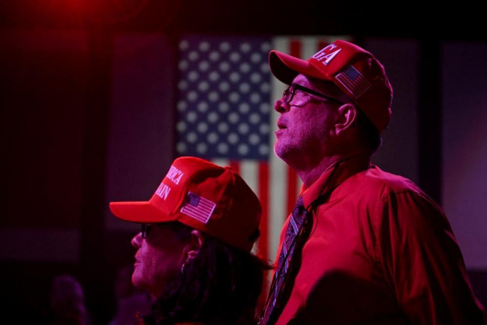 Mike and Dolly Rump of Madison County, Florida, wear MAGA (Make America Great Again) hats as they watch early election results at Republican presidential nominee and former U.S. President Donald Trump's election night watch party in Palm Beach County Convention Center, in West Palm Beach, Florida, U.S., November 5, 2024.