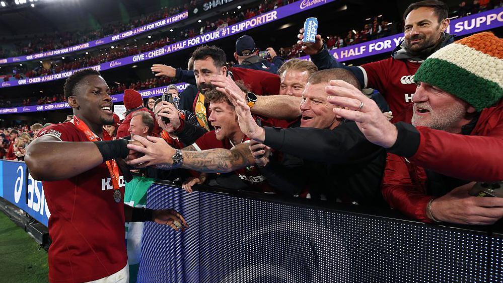 Maro Itoje celebrates pinch Lions fans
