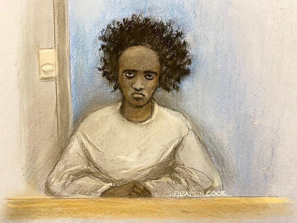 Artist's court sketch of Rudakubana. He is pictured in the court dock with long afro hair, wearing a long-sleeved white t shirt.