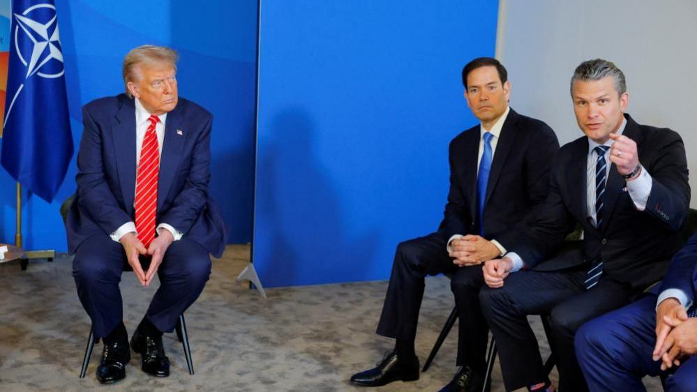 U.S. Secretary of Defense Pete Hegseth speaks next to U.S. Secretary of State Marco Rubio with U.S. President Donald Trump