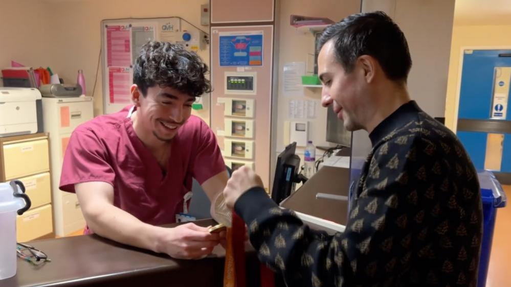 Will Bayley shows his gold medal to Brighton hospital staff for Christmas