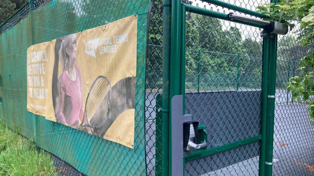 Russell Park tennis courts with a lock on it 