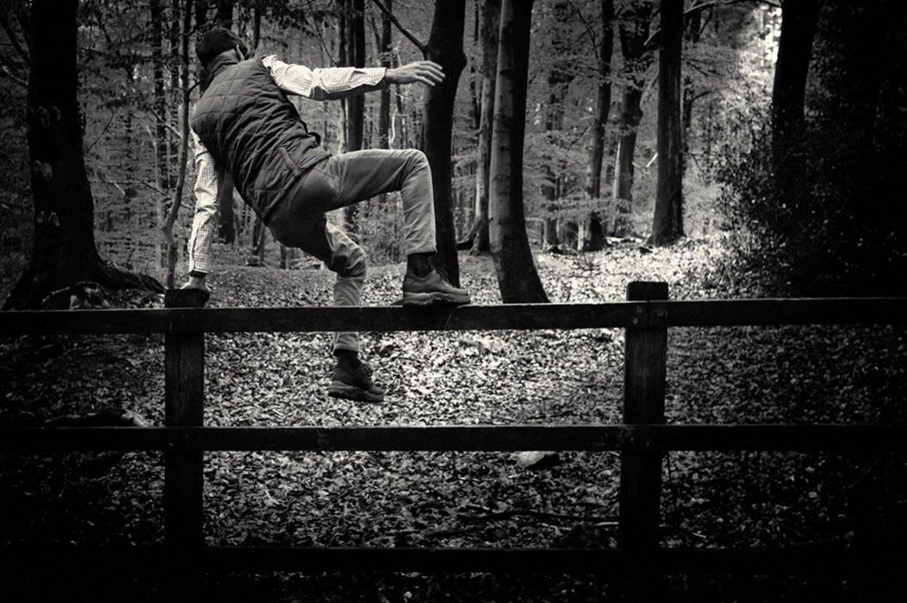 Man jumping a fence