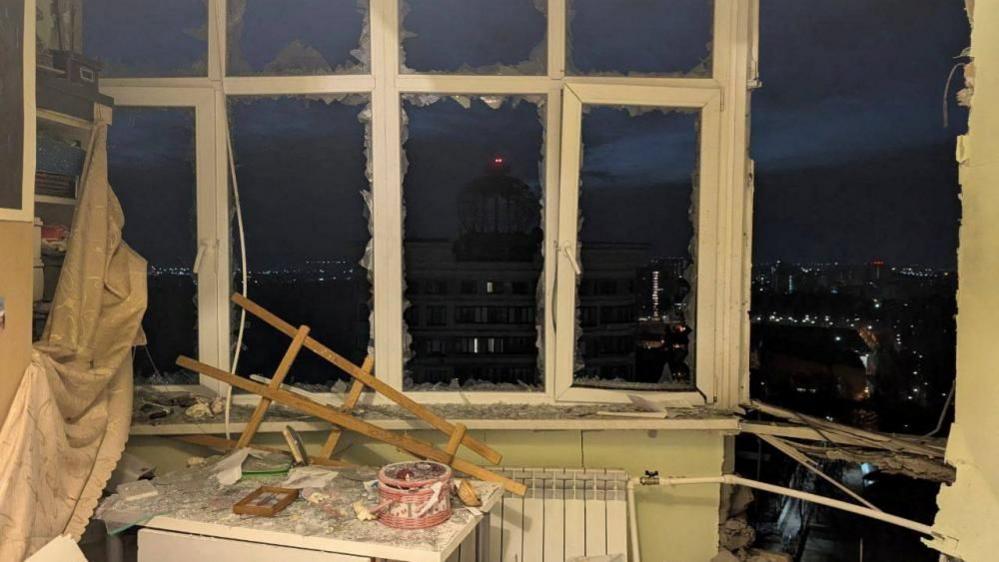 Destruction after a drone attack in Moscow, with windows shattered and a room damaged. 