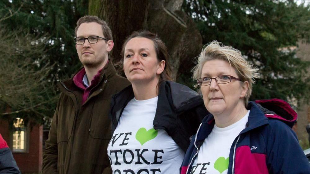 Local MP Darren Jones stands next to two campaigners wearing We Love Stoke Lodge t-shirts.