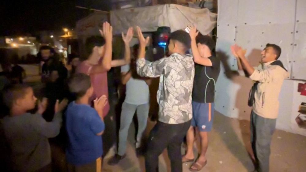 Palestinians celebrate in the streets of Khan Younis