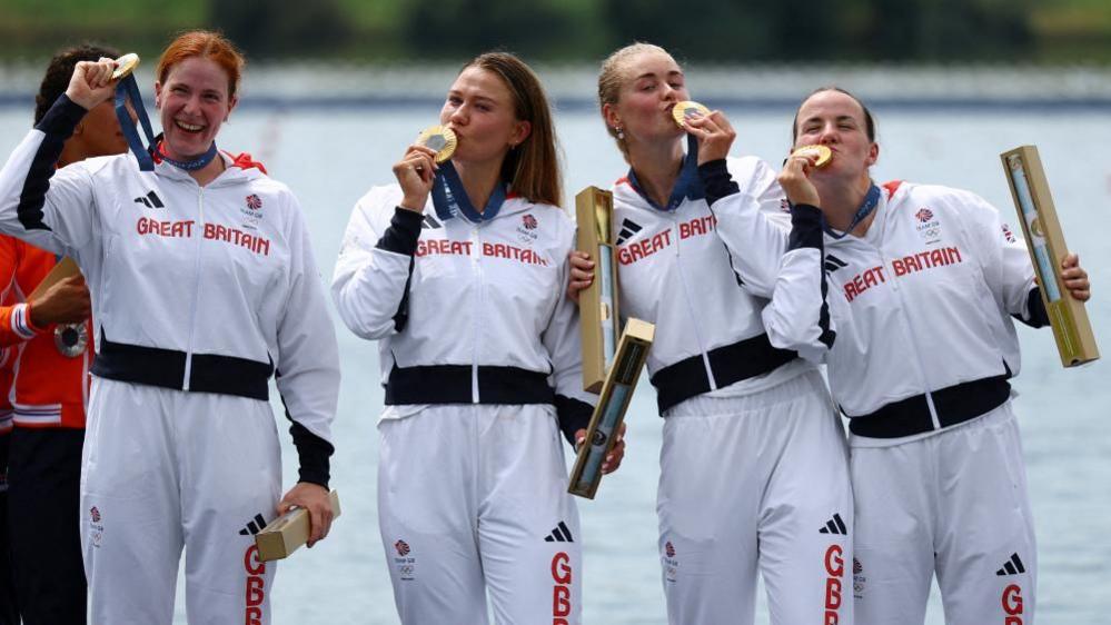 Left to right: Georgie Brayshaw, Lola Anderson, Hannah Scott and Lauren Henry kiss their gold medals