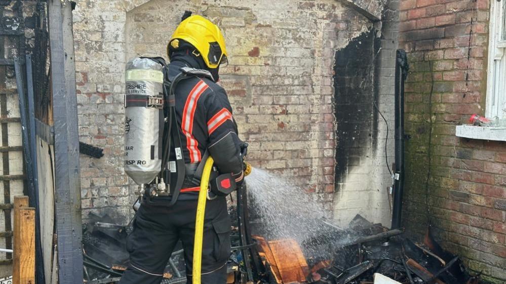 Firefighter spraying water from hose