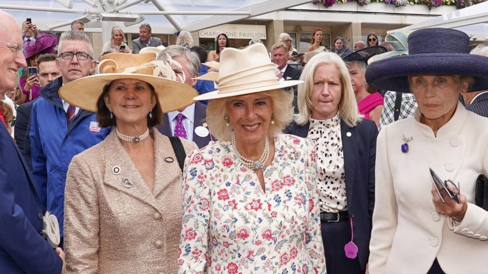 Britain's Queen Camilla meets representatives from local charities supported by York Racecourse, members of the Yorkshire racing community and staff members at the Ebor Festival at York Racecourse in York, Britain, August 21, 2025.