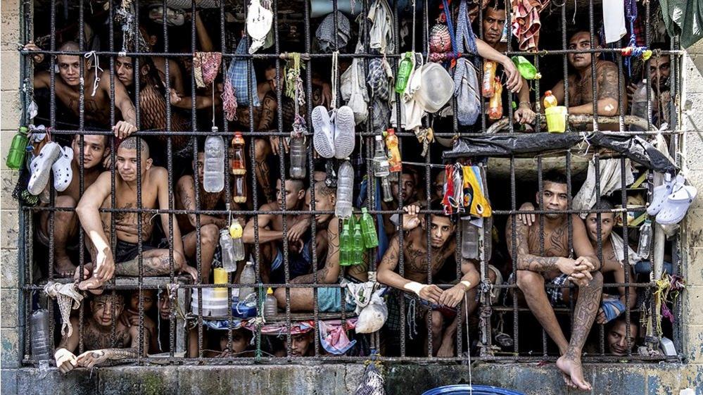 Inmates look out of an overcrowded cell in the Penal Center of Quezaltepeque, El Salvador. 9 November, 2018