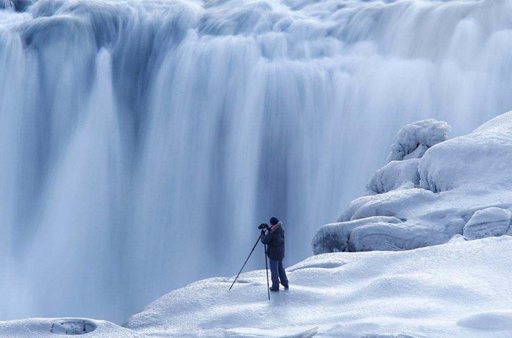 Photographer and waterfall