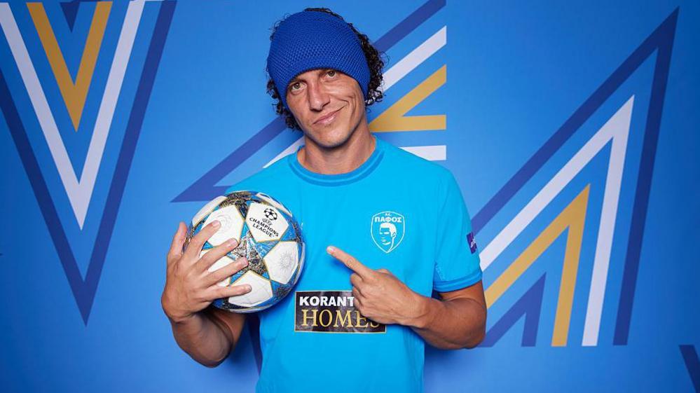 David Luiz points at a football