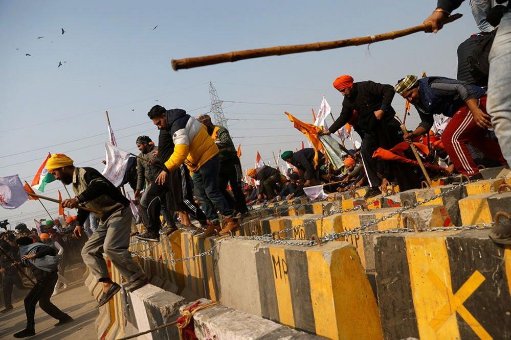 Farmers cross a barricade