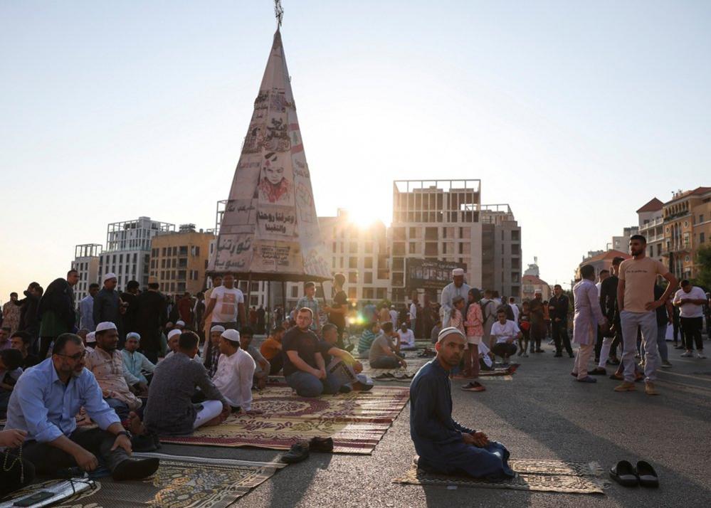 Muslims stay gathered after their first prayer on the first day of Eid al-Adha in front of Al-Amin mosque in downtown Beirut, Lebanon