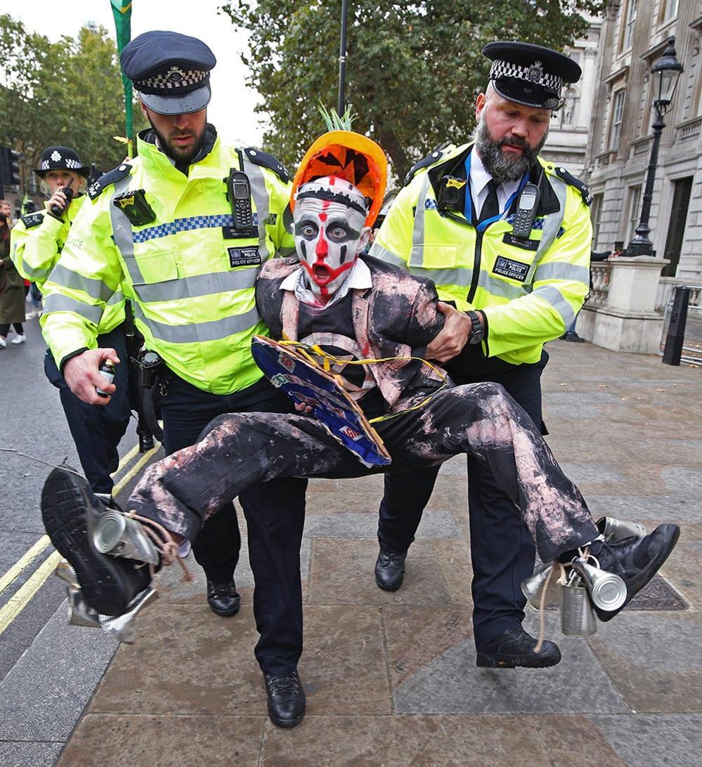 Police hold a protester during an Extinction Rebellion demonstration