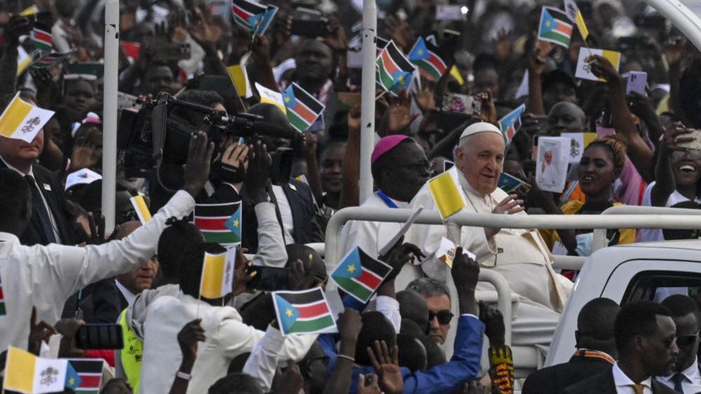 Pope Francis surrounded by crowds