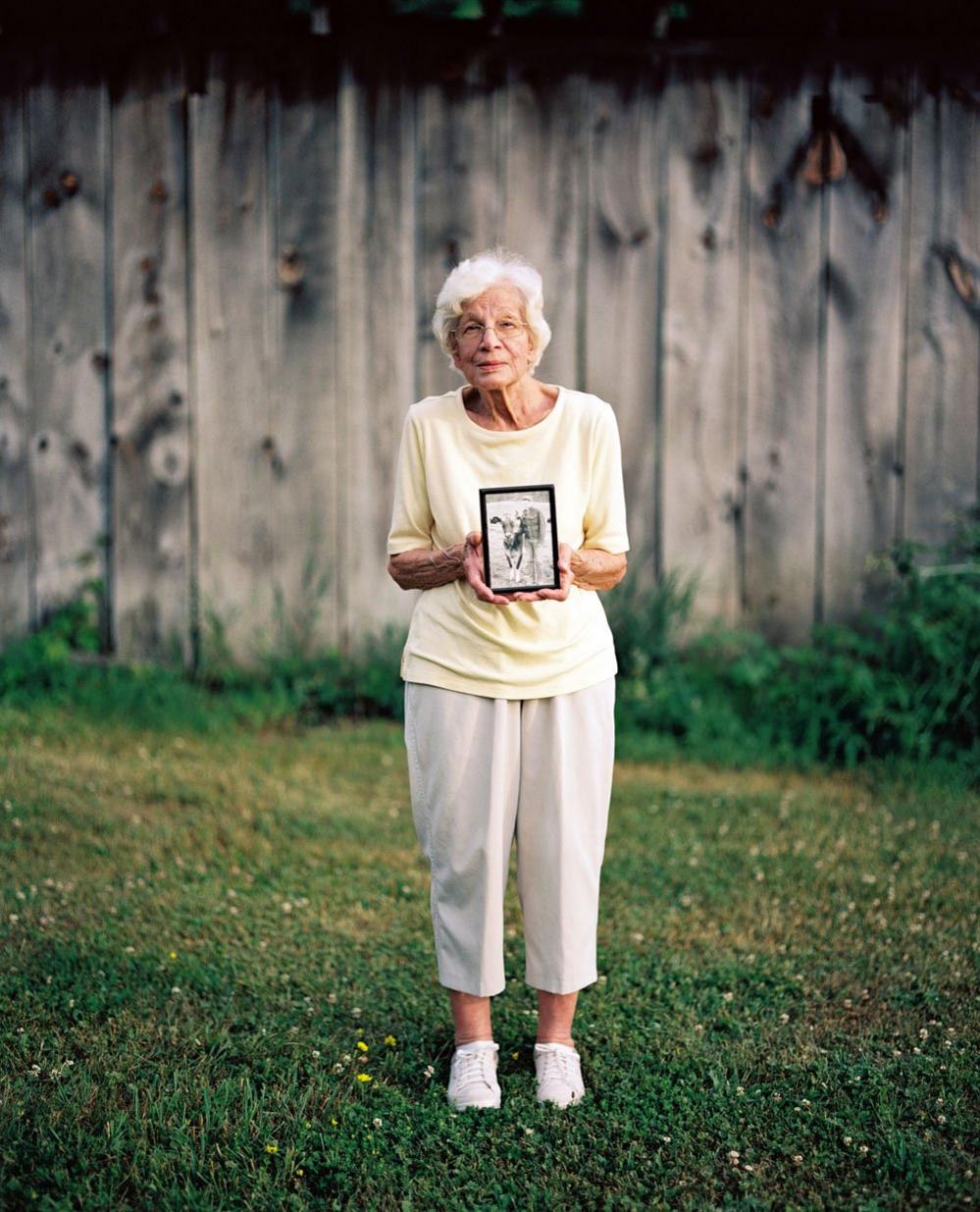 Jean Nyfeler, holding photo of late husband, Walt