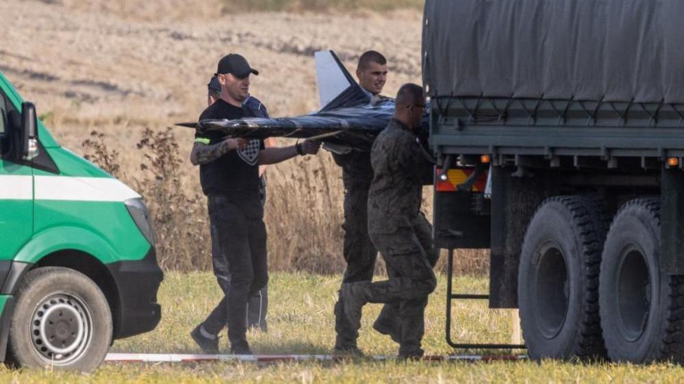 Polish National Territorial Defense Forces at the crash site of a Russian drone in the village of Wohyn