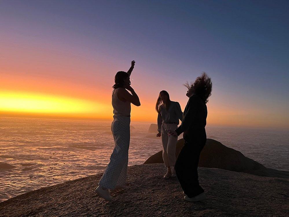 People dancing beside the sea