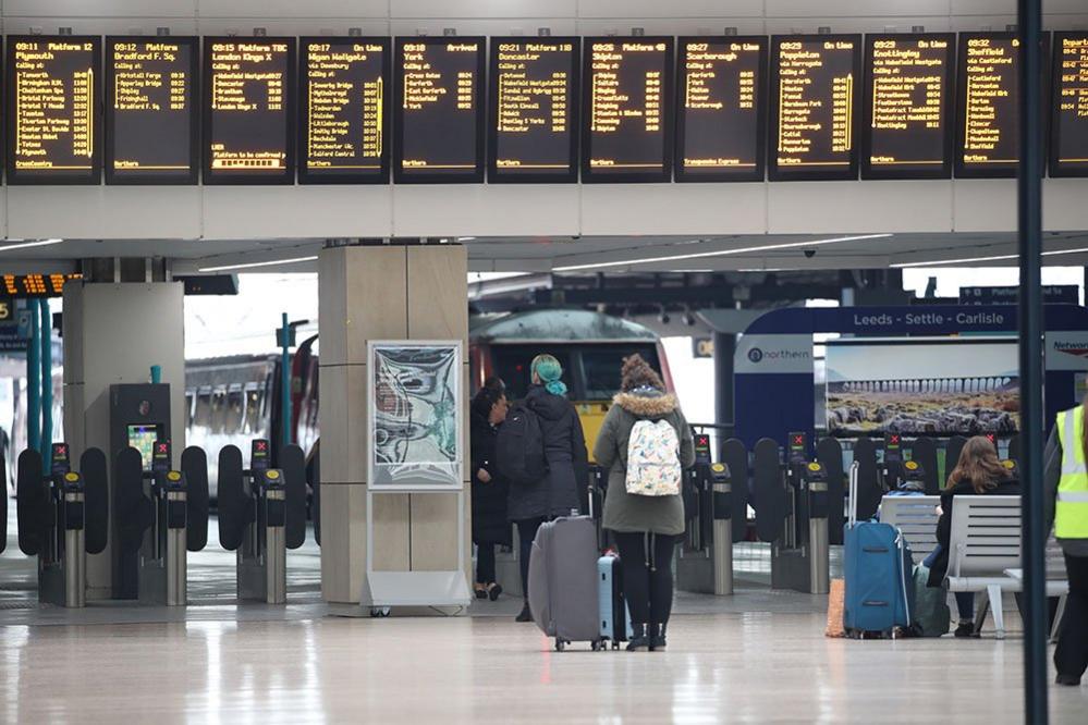 Passengers view the departures boards at Leeds train station just before 9.00am on the day after Prime Minister Boris Johnson put the UK in lockdown to help curb the spread of the coronavirus