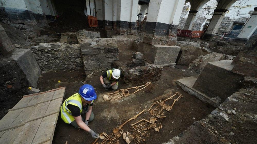 Archaeologists examine the remains at the site of St Mary's Abbey