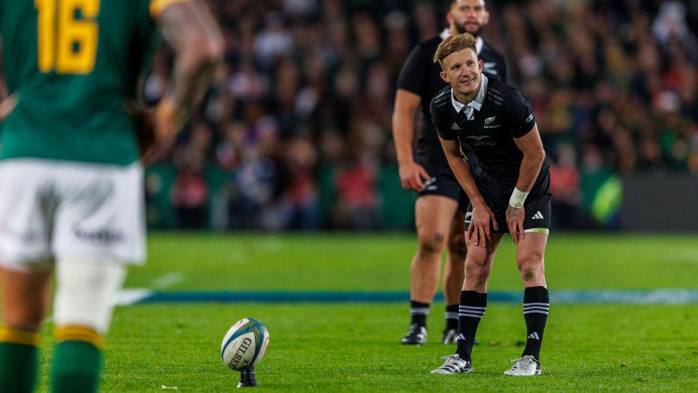 Damian McKenzie lines up a kick